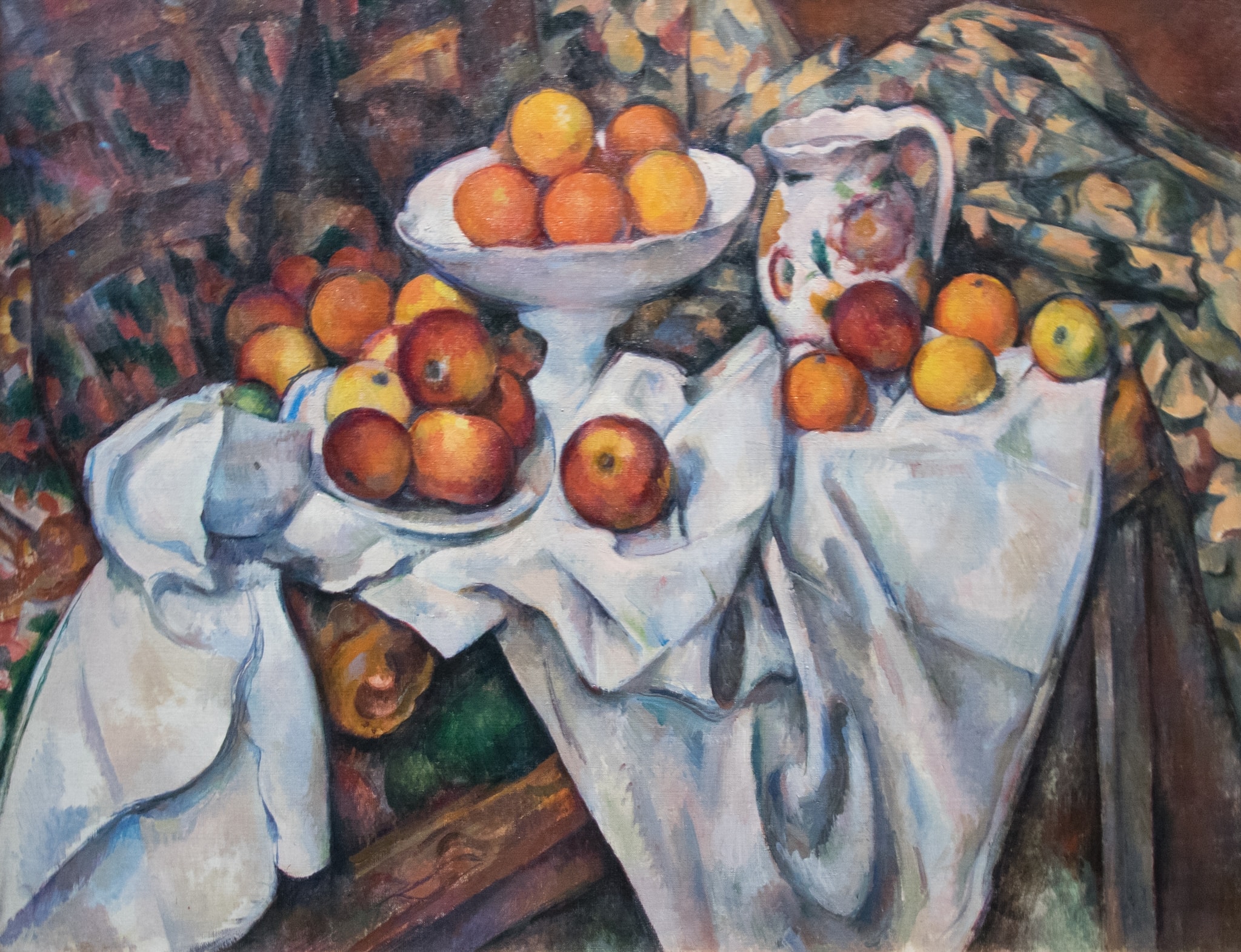 Still Life with Apples and Oranges by Paul Cézanne (c. 1899) featuring Apples, Oranges, White Drapery/Cloths, Footed Compote (Bowl)